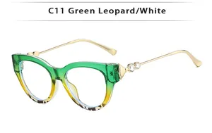 Détail de lunettes de soleil œil de chat avec dégradé léopard vert et branches en métal strass