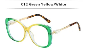 Detail of gradient frame sunglasses with gold temples and white pearl accents