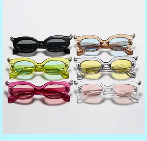 Flat lay of retro cat-eye sunglasses in multiple colors with unique horn-shaped frames