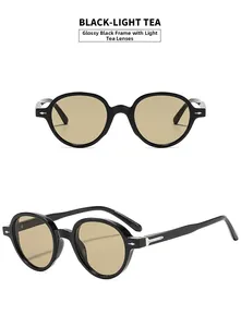Detail view of round sunglasses in glossy black frame with light brown lenses