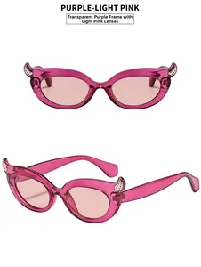 Detail of cat eye sunglasses with devil horns and transparent purple frame lenses