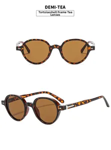 Detail view of round retro sunglasses with demi frames, tea lenses, and silver arrow accents