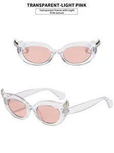Detailed view of cat eye sunglasses with transparent light pink frames and metal beads