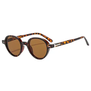 Retro round tortoise shell sunglasses with brown lenses and metal arrow rivets