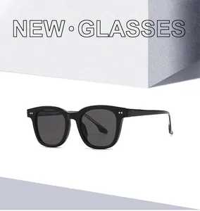 Close-up of classic black TR frames with silver rivet detail and dark lenses