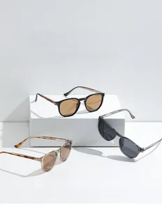 Detailed view of vintage polarized sunglasses in black, grey, and tea colors on display