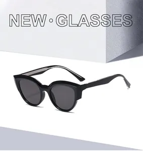 Detailed view of trendy black TR90 cat eye sunglasses on white geometric stone backdrop