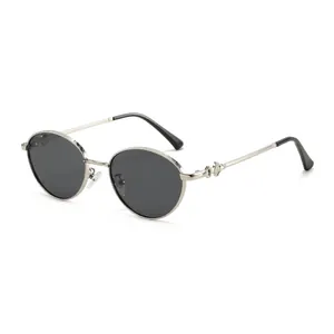 Retro oval metal sunglasses with engraved silver frames and dark protective lenses