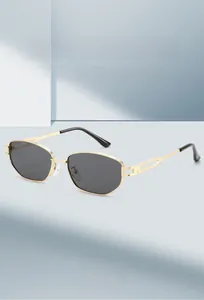 Macro detail of hexagonal gold metal frames and dark lenses on fashion sunglasses