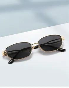 Detailed macro view of gold metal sunglasses frame with geometric hollow engraving on temples