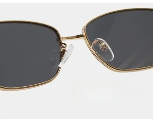 Detail of adjustable eco-friendly silicone nose pads on golden metal sunglasses