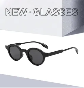 Detailed close-up of retro round black sunglasses on minimalist geometric blocks
