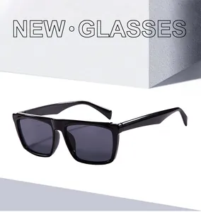 Close-up of black square frame sunglasses with dark lenses on a white textured background