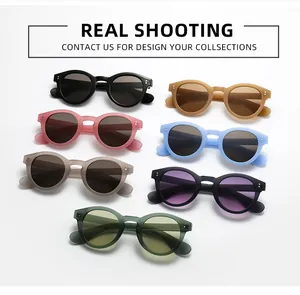 Flat lay of retro round frame sunglasses in seven matte colors with rivet details
