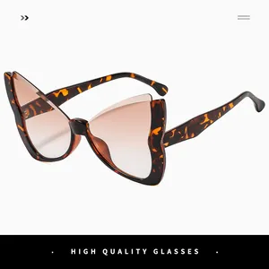 Detail view of butterfly frame sunglasses with tortoiseshell pattern and gradient lenses