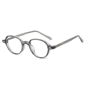 Retro small oval sunglasses with translucent grey TR90 frame and metal rivet details