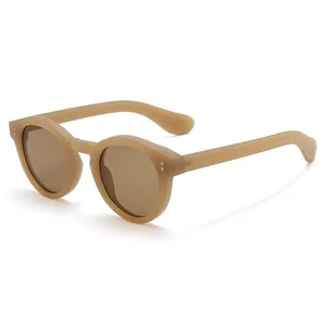 Classic round sunglasses in matte light brown with retro metallic dot details