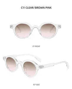 Detailed view of vintage round sunglasses with clear frames and brown pink gradient lenses