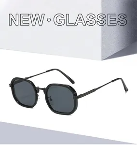 Détail macro de lunettes de soleil hexagonales noires avec verres foncés sur pierre