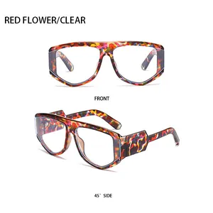 Detail showing the red floral pattern frame and clear lenses of the large square sunglasses