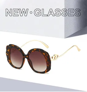 Close-up of tortoise shell frame and golden metal temples with hollow heart details