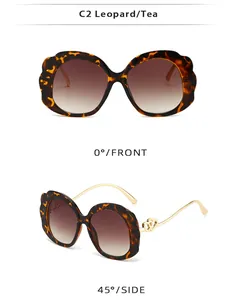 Detail of leopard print oval sunglasses with gold double-heart hinge and gradient lenses