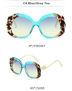Detail view of oval sunglasses with wavy frames, gold temples and double heart metal trim