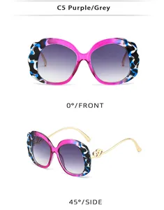 Detail of oval purple sunglasses with marble texture frames and double-heart metal décor