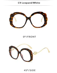 Detail view of leopard print oval sunglasses with gold double heart accents and petal edges