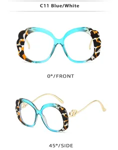 Detail of blue tortoiseshell oval sunglasses with gold heart metal temple accents