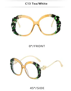Detail view of oval sunglasses with scalloped tortoiseshell frames and gold heart metal accents