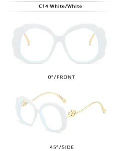 Detail view of oval white eyewear with golden heart hinges and clear lenses
