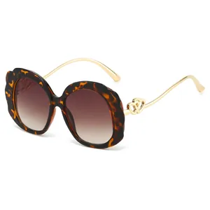 Fashionable oval tortoiseshell petal frame sunglasses with gold heart metal temple details