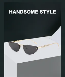 Detailed close-up of golden metal sunglasses temples featuring elegant white pearl accents