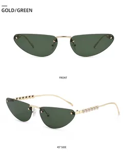 Detail of cat eye rimless sunglasses with gold frame, green lens and pearl-embellished temples