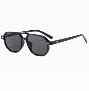 Detail shot of black double-bridge aviator sunglasses with dark lenses and silver studs
