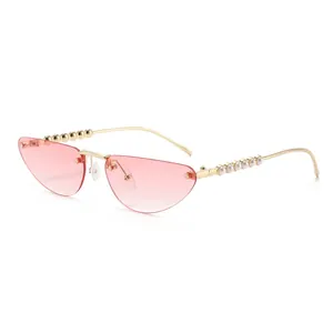 Cat eye rimless sunglasses with pink gradient lenses and pearl-embellished gold temples