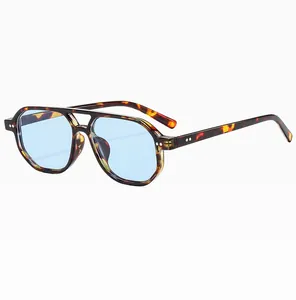 Detail view of tortoiseshell aviator sunglasses with dual bridge and light blue lenses
