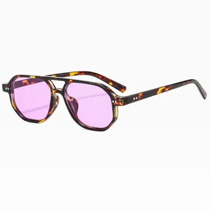 Detailed close-up of tortoise shell aviator sunglasses with purple lenses and silver rivets