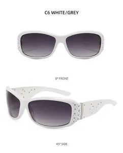 Detail view of white rhinestone sunglasses with grey gradient lenses and floral temples