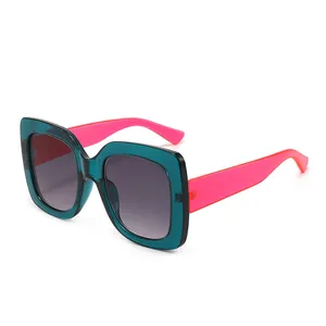 Chic square two-tone sunglasses with transparent green frames and vibrant pink temples