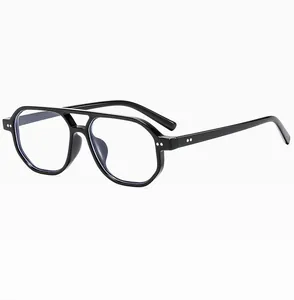 Close-up of black aviator sunglasses featuring double bridge and metallic rivet details