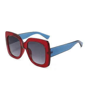Fashionable square frame sunglasses with red and blue contrast design and gradient grey lenses