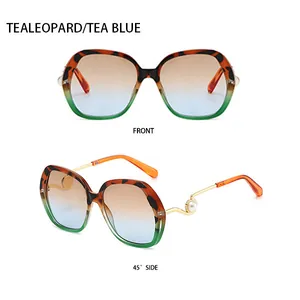 Detail view of fashion oversized sunglasses with pearl decor and gradient lenses