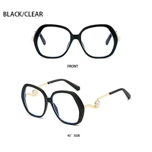 Detail of oversized polygonal sunglasses with black frames and pearl metal temple accents