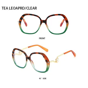 Detailed view of oversized tea leopard sunglasses with pearl detail and gold metal temples