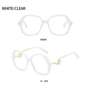 Detail of oversized white frames with golden metal temples and decorative pearl accents