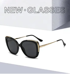 Detailed close-up of retro black frame sunglasses with golden metal grain texture