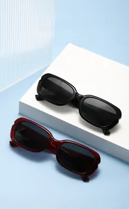Detail showing wavy textured temples on black and burgundy rectangular sunglasses
