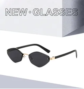 Macro detail of rimless geometric sunglasses with gold bridge and grey lenses